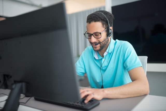 Two IT staff reviewing a help desk dashboard together